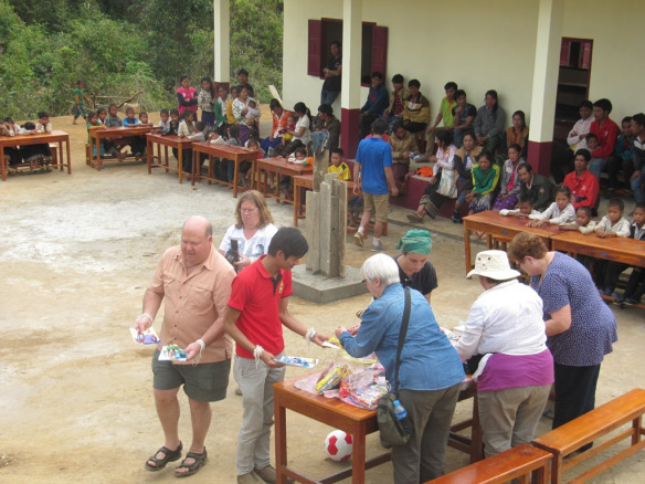 Despite receiving confirmation that there were 72 students, it turns out that there were over 100.  So we didn't have enough for everyone! (we returned another day to give to the students without). Paulette, both Kathys, Carol and Mike were on hand to distribute school supplies, balloons, candy (just one), toothbrushes and toothpaste to each student.